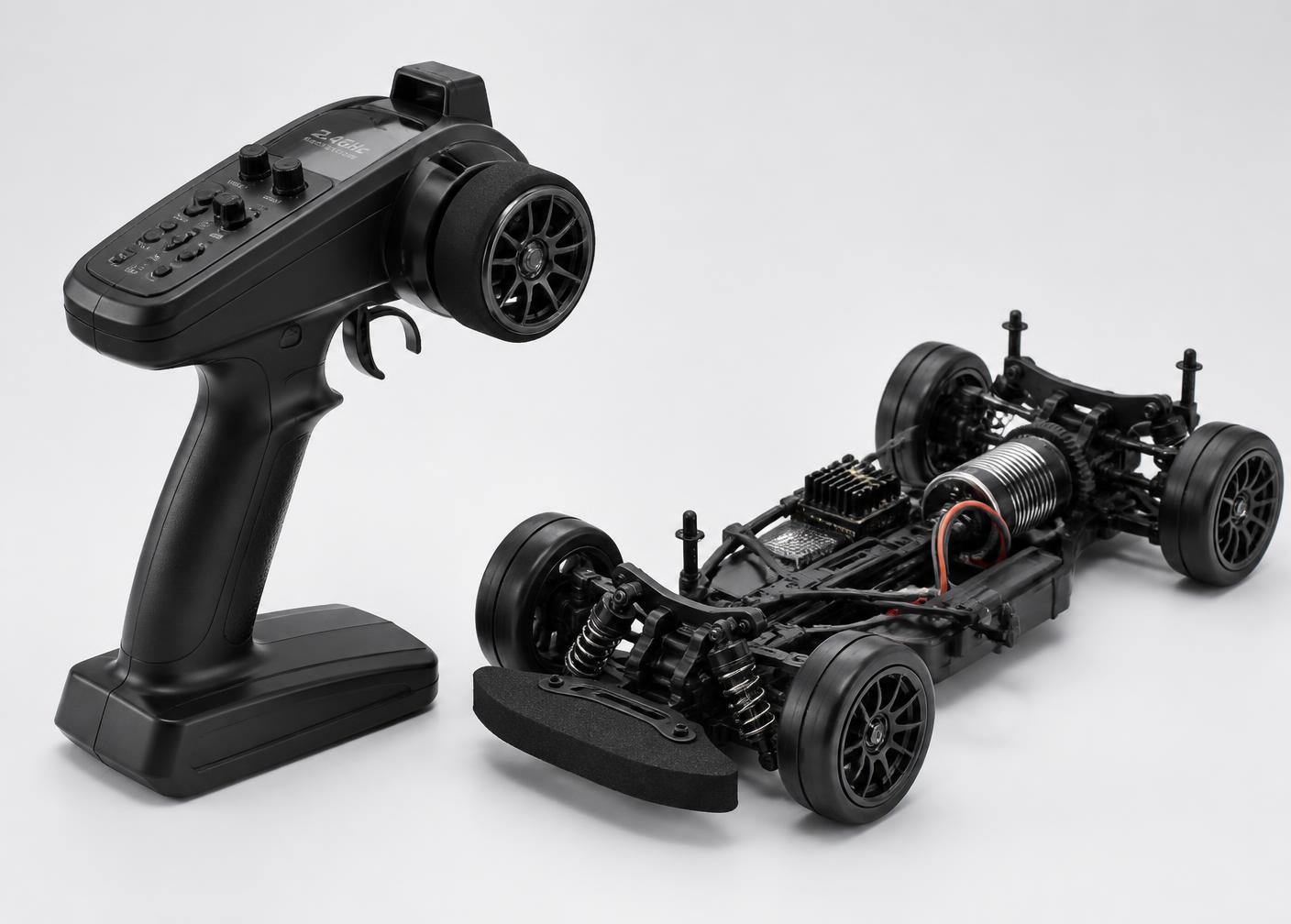 2.4GHz remote control next to the RC car chassis